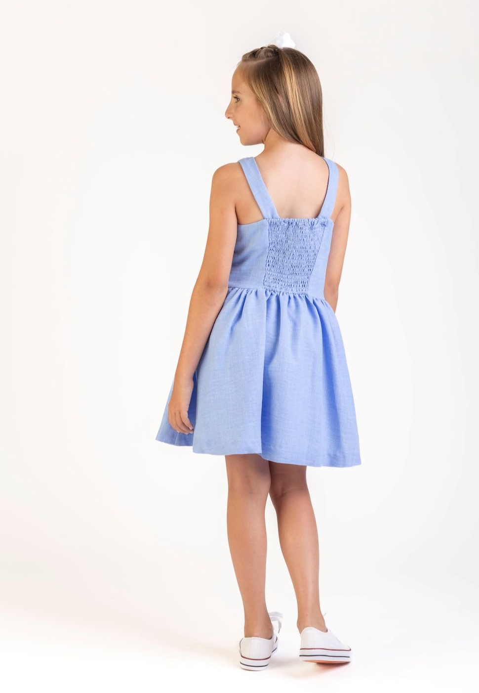 Little girl’s Gabby Willow Blue Pleated Dress with smocked back and side pockets, perfect for twirling and summer fun.