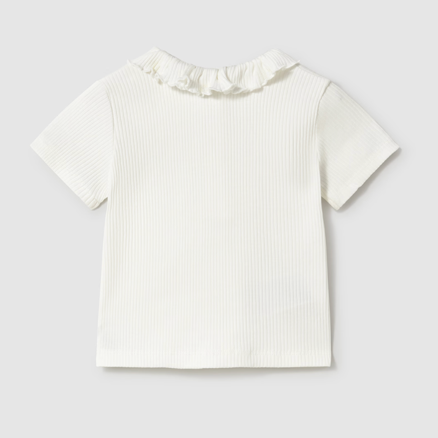 Cream ribbed girls’ long sleeve top with ruffle collar, perfect for layering or wearing alone.
