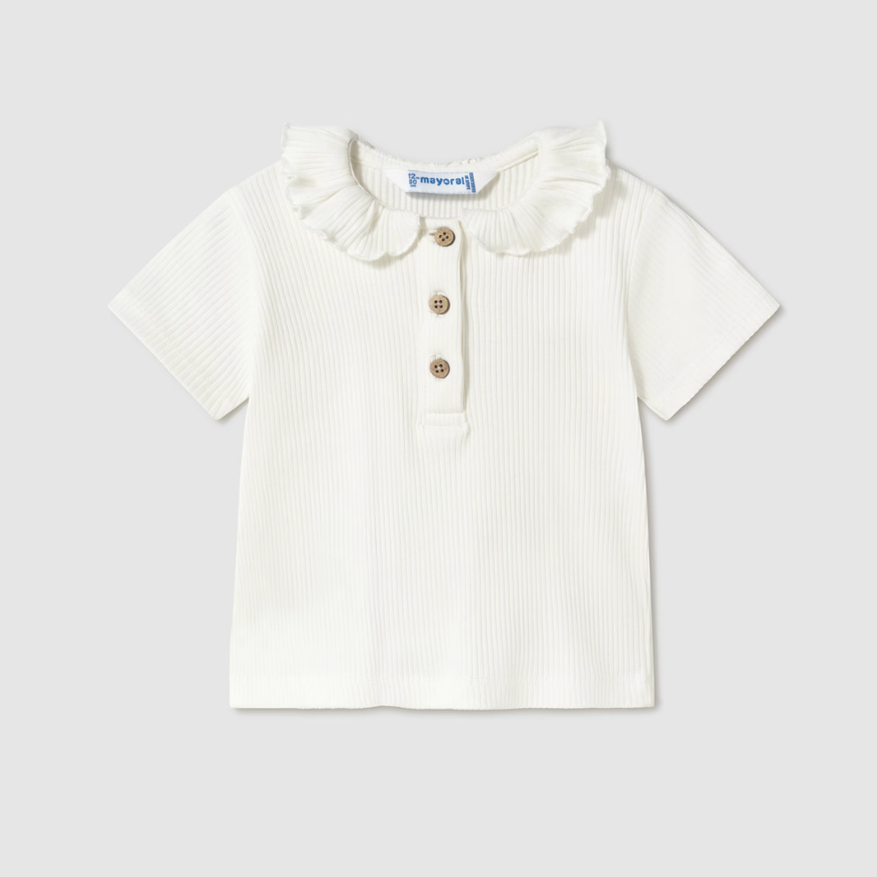 Cream ribbed girls’ long sleeve top with ruffle collar, perfect for layering or wearing alone.