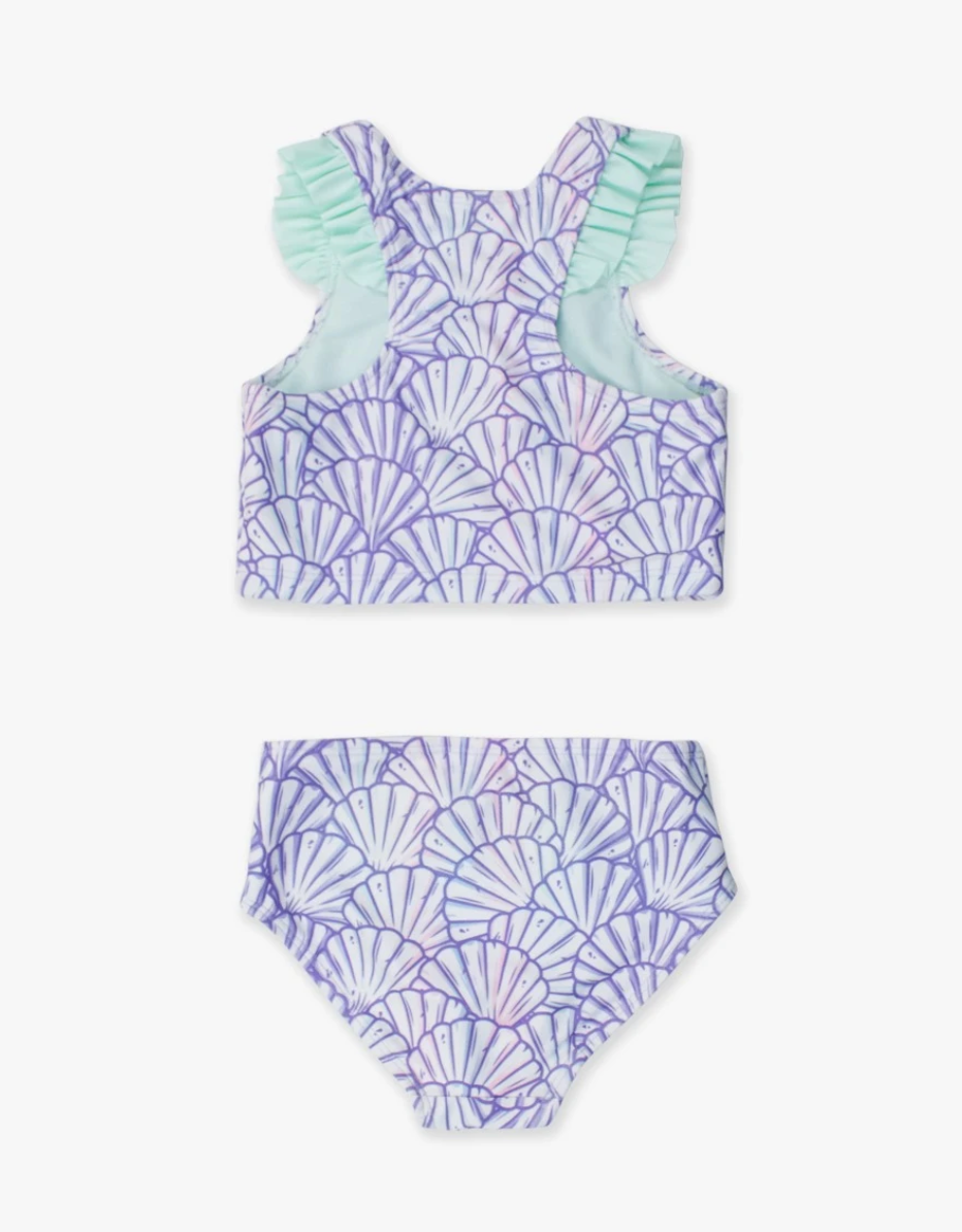 Young girl’s purple mermaid-themed racerback tankini with flutter ruffle straps, shown in two-piece set on white background.