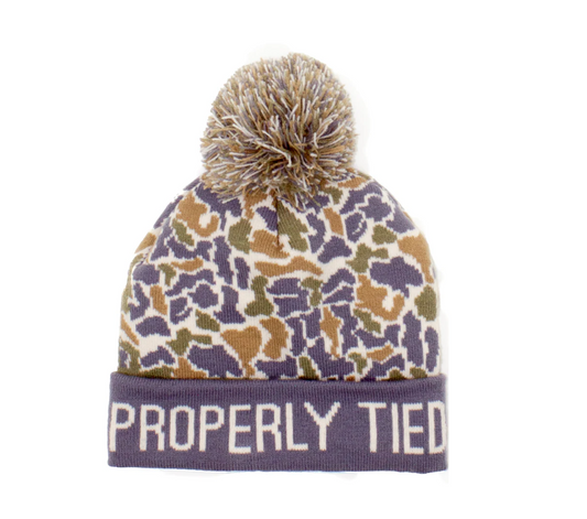 Kids' camo knit beanie with cuffed edge and pom-pom, Properly Tied Breck Beanie in Field Camo, made from soft polyester for cold weather comfort.