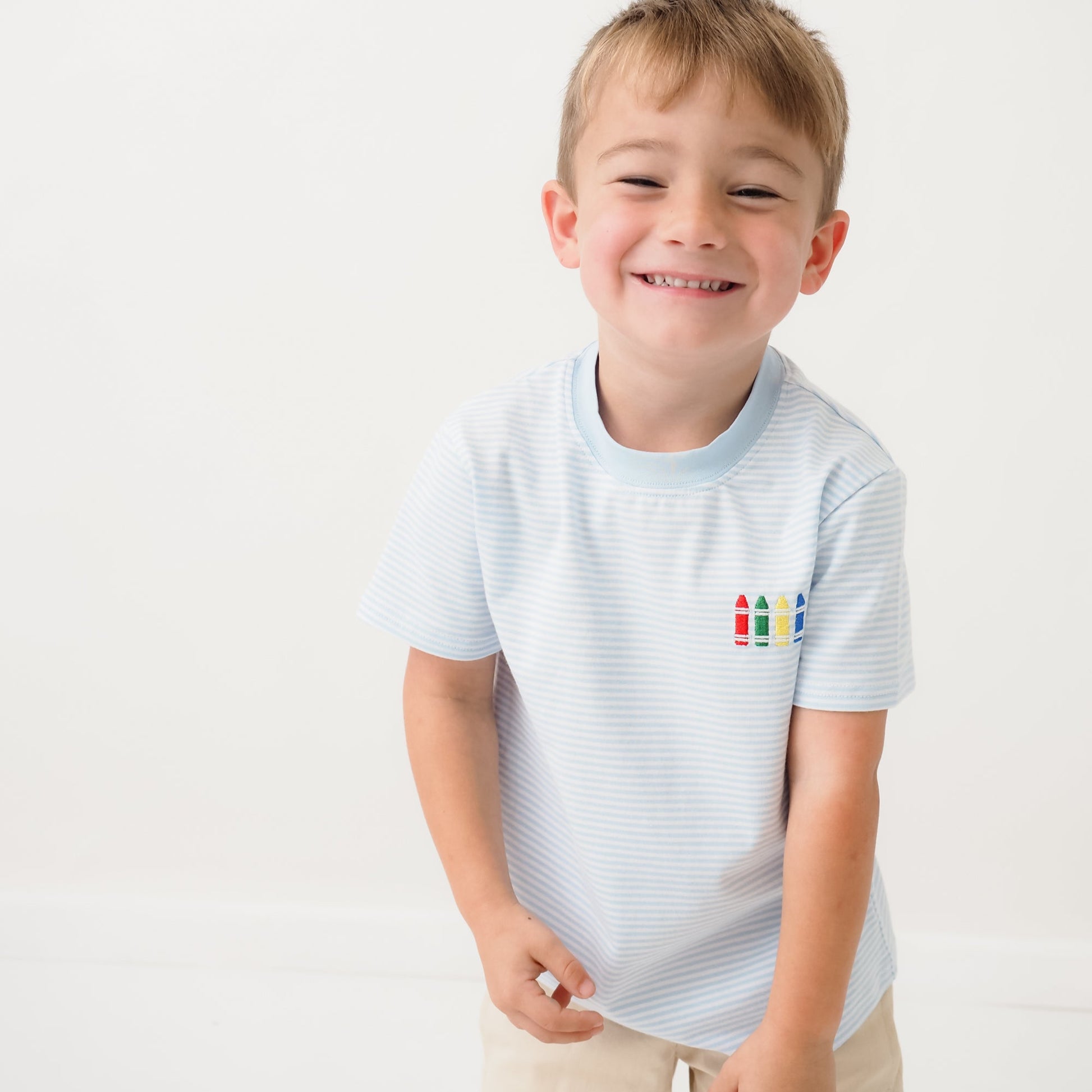 Boys striped back to school tee with light blue stripes and crayon graphic on chest, made from soft cotton spandex blend.