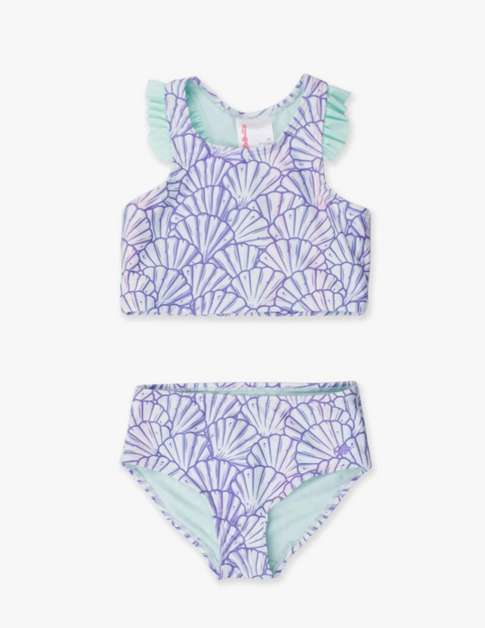 Young girl’s purple mermaid-themed racerback tankini with flutter ruffle straps, shown in two-piece set on white background.